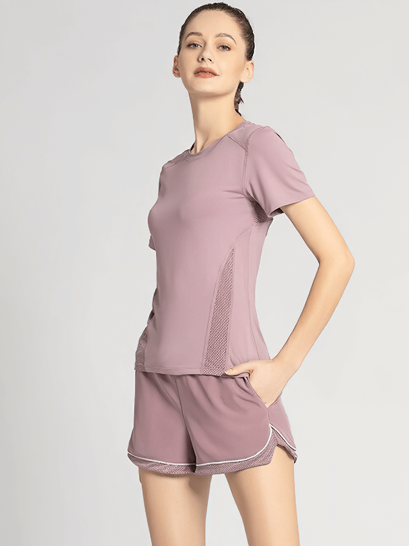 Woman wearing athletic round neck quick dry t-shirt with mesh back, perfect for yoga. SF0111 classic fit, polyester-spandex blend.